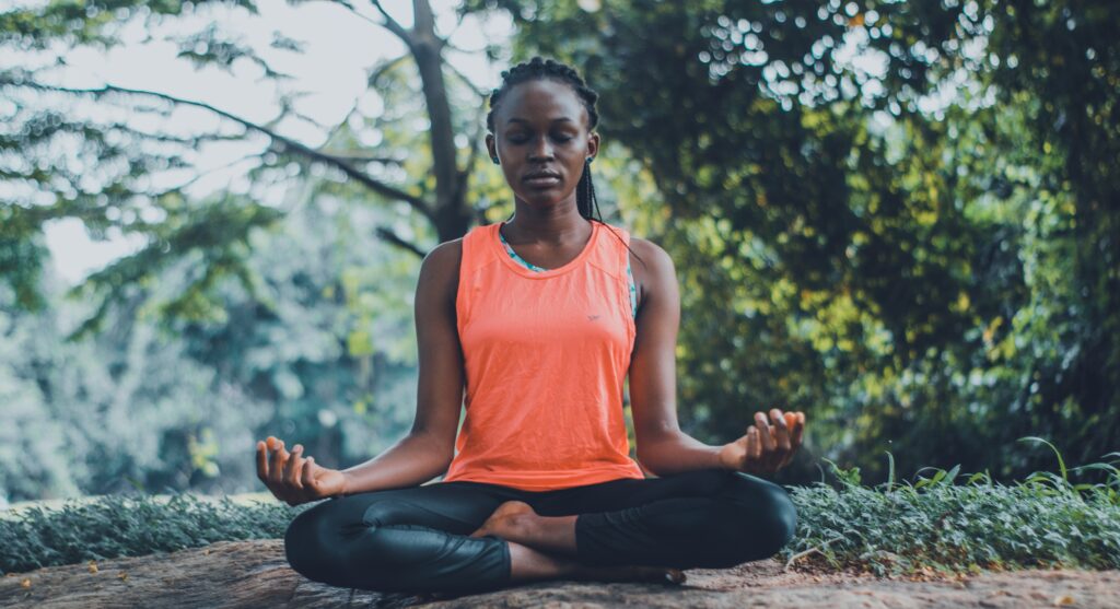 Woman meditating in the forest