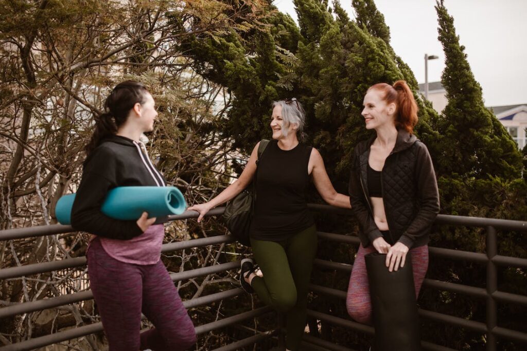 three woman talking aft exercising